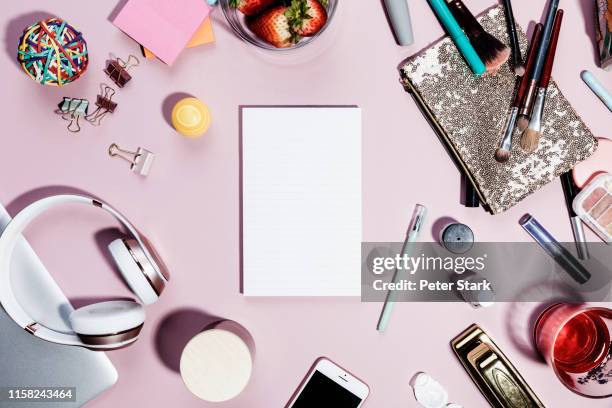 view form above blank notepad surrounded by personal belongings on pink background - knolling concept stock pictures, royalty-free photos & images