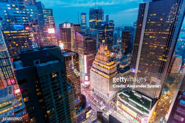 times square aerial view at night with illuminated skyscrapers, new york, usa - broadway street stock pictures, royalty-free photos & images
