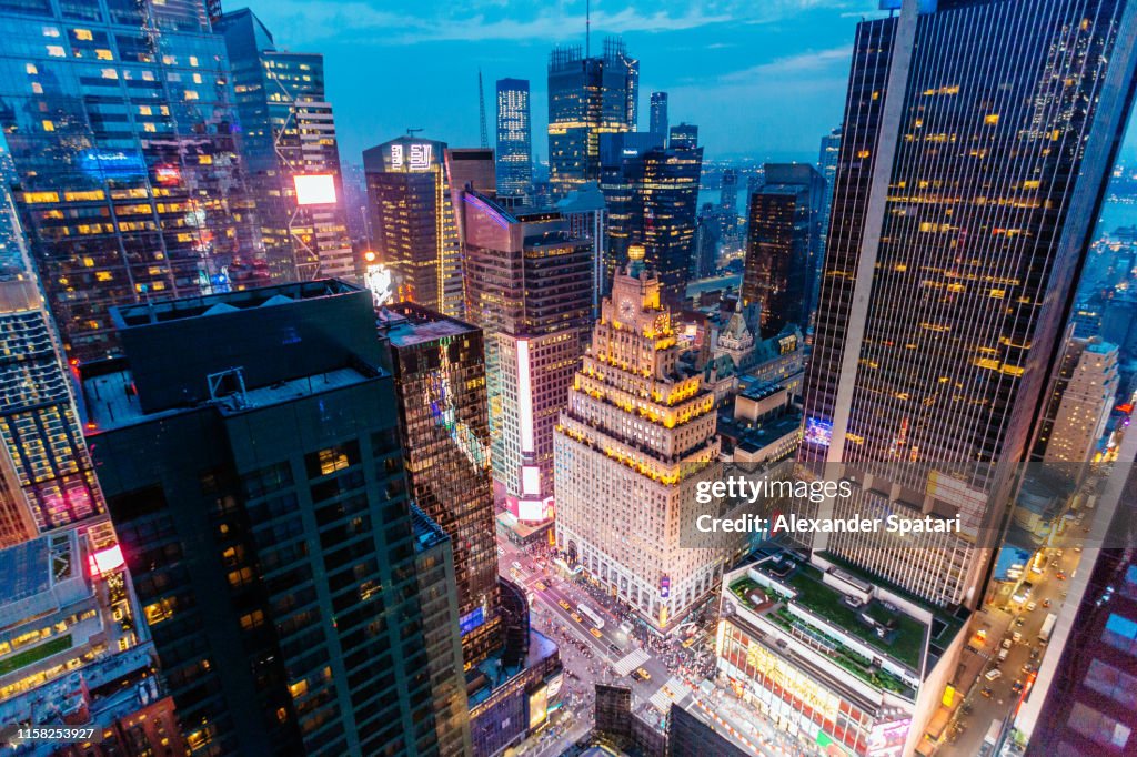 Times Square aerial view at night with illuminated skyscrapers, New York, USA