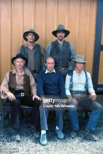 British Film Director Richard Lester sits with stars Tom Berenger and William Katz and two cowboy extras on the set of movie "Butch and Sundance --...