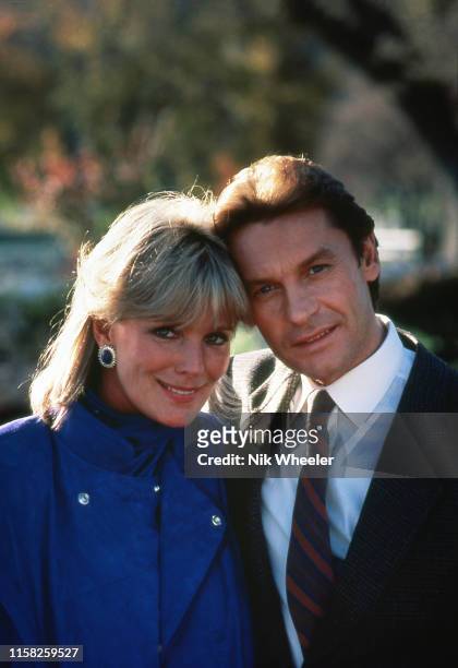 Stars of the television hit series "Dynasty" Austrian actor Helmut Berger and American actress Linda Evans pose for photo during break in filming in...