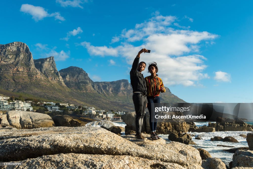 Couple taking selfie on smart phone at beach