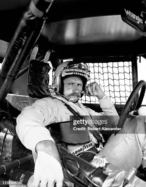 Driver Dale Earnhardt Sr. Sits in his racecar prior to the start of the 1981 Firecracker 400 NASCAR race at Daytona International Speedway in Daytona...