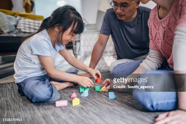 parents playing with daughter - block flats stock pictures, royalty-free photos & images