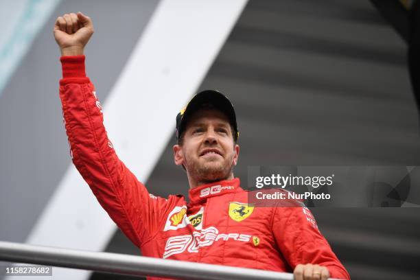 German four time World Champions Sebastian Vettel of Italian team Scuderia Ferrari Mission Winnow under the podium and in podium ceremony during the...