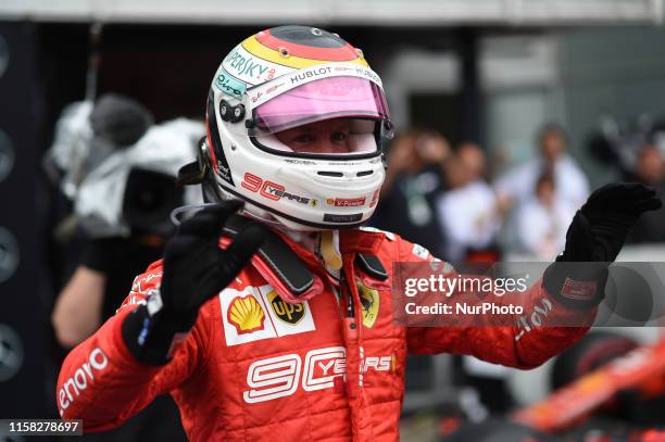 German four time World Champions Sebastian Vettel of Italian team Scuderia Ferrari Mission Winnow under the podium and in podium ceremony during the...