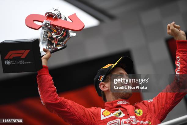 German four time World Champions Sebastian Vettel of Italian team Scuderia Ferrari Mission Winnow under the podium and in podium ceremony during the...