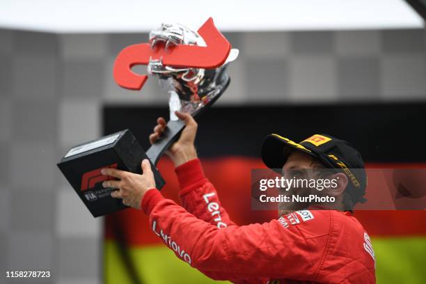 German four time World Champions Sebastian Vettel of Italian team Scuderia Ferrari Mission Winnow under the podium and in podium ceremony during the...