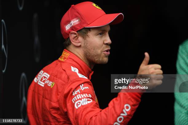 German four time World Champions Sebastian Vettel of Italian team Scuderia Ferrari Mission Winnow under the podium and in podium ceremony during the...