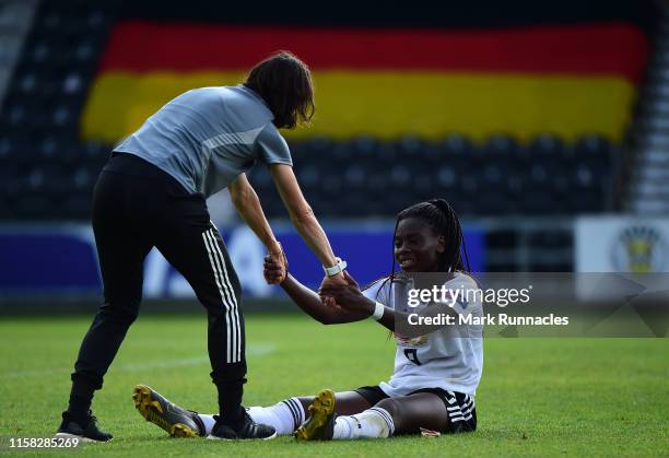 Nicole Anyomi of Germany is helped to her feet after Germany lost out to France 2-1 during the UEFA Women's Under19 European Championship Final...