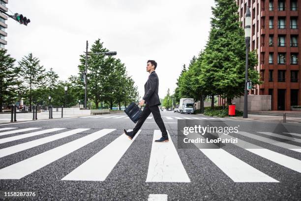 livet på språng i affärs distriktet. japansk affärs man i tokyo finans distrikt - business man walking with a bag in asia bildbanksfoton och bilder