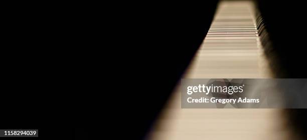 piano keys on a black background with space for copy - classical category stock pictures, royalty-free photos & images