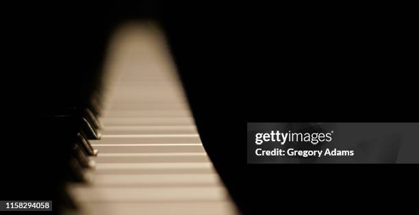 piano keys on a black background with space for copy - classical category stock pictures, royalty-free photos & images