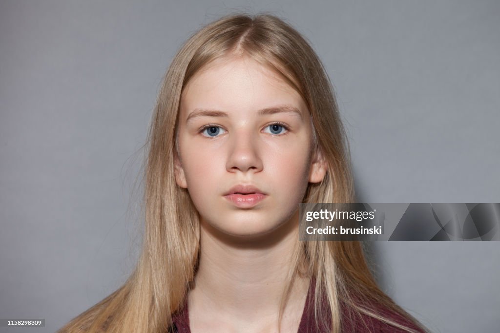 Studio Portrait Of Blonde Teen Girl On Gray Background High Res Stock studio-portrait-of-blonde-teen-girl-on-gray-background-high-res-stock