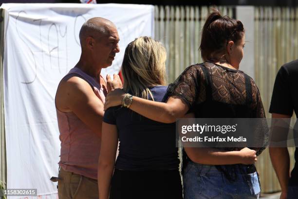 Friends grieve outside tributes to Tom and Mia at the Home Hill Backpackers, south of Townsville, where Smail Ayad allegedly killed British...