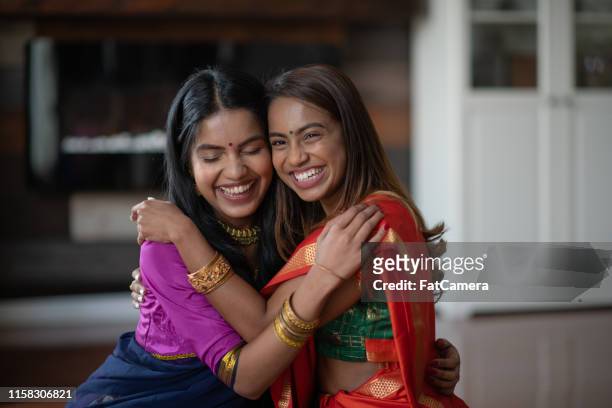 two (2) happy and attractive indian sisters - diwali stock pictures, royalty-free photos & images