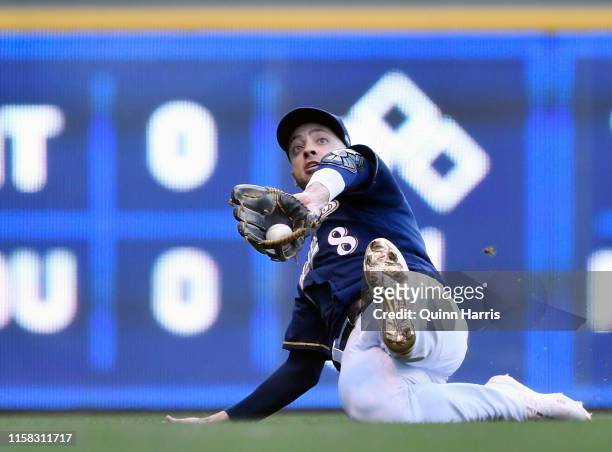 Ryan Braun of the Milwaukee Brewers slides to make the catch in the first inning against the Seattle Mariners at Miller Park on June 25, 2019 in...