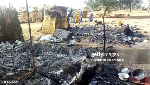 Smoldering ashes are seen on the ground in Badu near Maiduguri on July 28 after the latest attack this weekend by Boko Haram fighters on a funeral in...