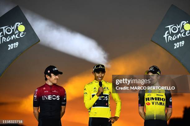 Colombia's Egan Bernal delivers a speech after receiving his overall leader's yellow jersey as he poses with second-placed Great Britain's Geraint...