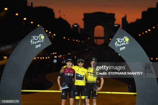 Colombia's Egan Bernal celebrates his overall leader's yellow jersey as he poses with second-placed Great Britain's Geraint Thomas and third-placed...