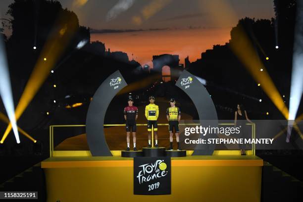 Colombia's Egan Bernal celebrates his overall leader's yellow jersey as he poses with second-placed Great Britain's Geraint Thomas and third-placed...