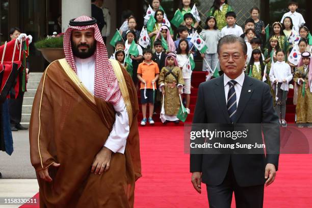 South Korean President Moon Jae-In and Saudi Crown Prince Mohammed bin Salman walk towards a guard of honour during a welcoming ceremony at the...