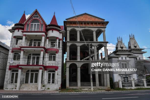 Palaces belonging to Romanian Roma people are pictured in Buzescu village, southern Romania, on July 11, 2019. - In Romania's fields or on the...