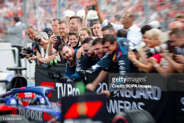 Scuderia Toro Rossos mechanics celebrate after being third in the German F1 Grand Prix race.