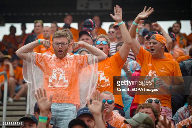 Dutch fans of Max Verstappen cheer during the German F1 Grand Prix race.