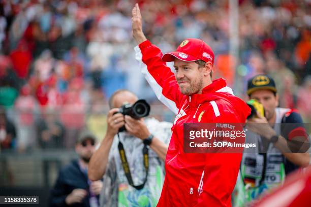 Scuderia Ferraris German driver Sebastian Vettel attends the drivers parade prior to the start of the German F1 Grand Prix race.