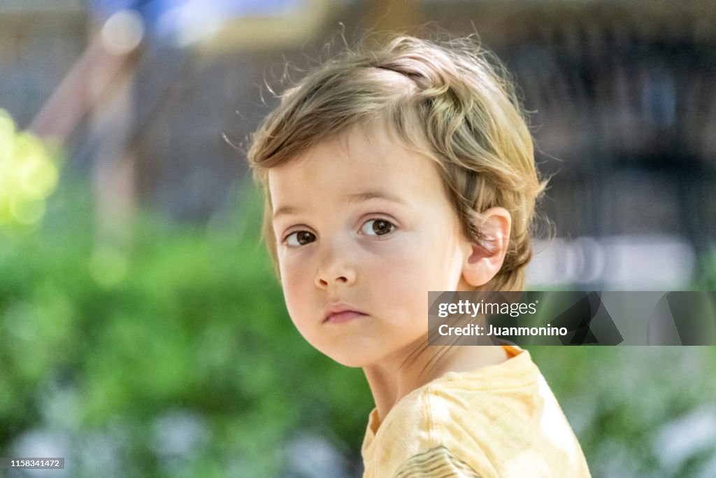 Three years old child boy looking at the camera