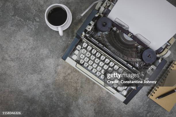 typewriter on rustic concrete background - antique desk stock pictures, royalty-free photos & images