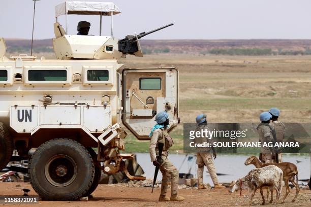 Senegalese soldierS the UN peacekeeping mission in Mali MINUSMA dismount an armoured personnel carrier, patrolling in the streets of Gao, on July 24...