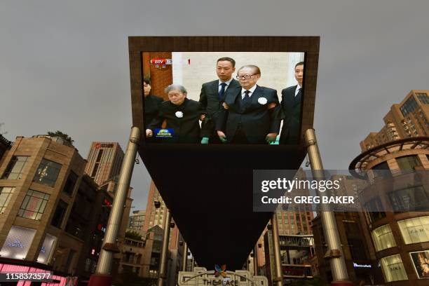 News program showing former Chinese former president Jiang Zemin paying his respects at the funeral of former Chinese Premier Li Peng is displayed on...