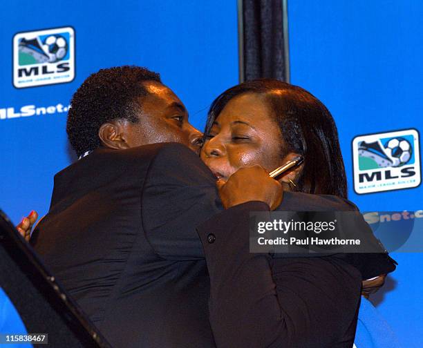 Freddy Adu hugs his mother Emeila, after giving her the pen he used to sign his contract with during a news conference announcing his multi year deal...