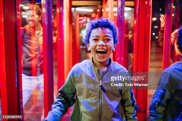 young boy smiling while in hall of mirrors - fun house stock pictures, royalty-free photos & images