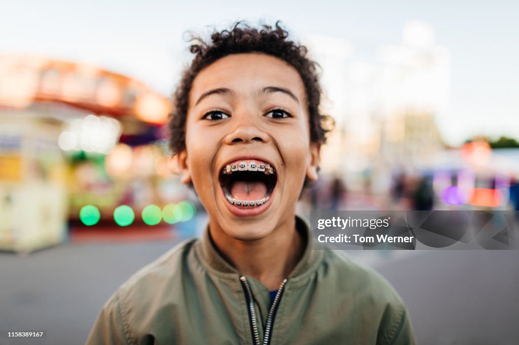 Young Boy With Mouth Wide Open At Fun Fair