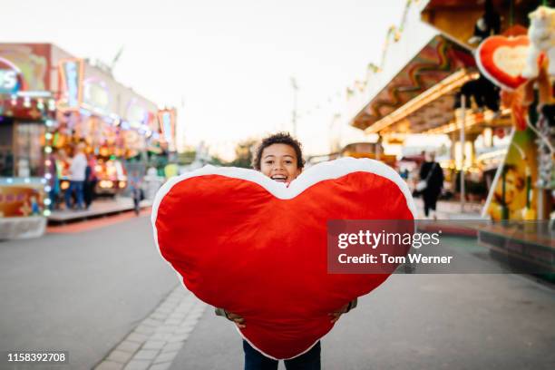young boy holding large prize he won at fun fair - big tom stock pictures, royalty-free photos & images