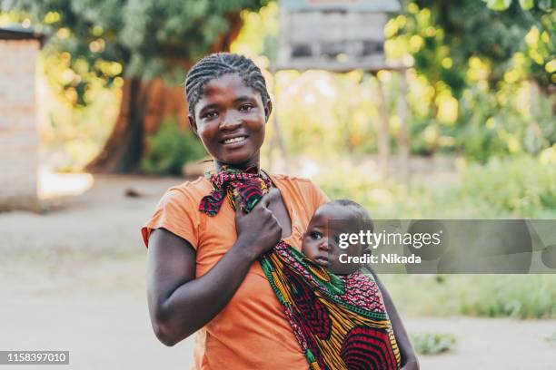 african mother with baby son at home - malawi stock pictures, royalty-free photos & images