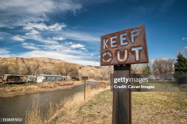 keep out sign along the colorado river - keep out sign stock pictures, royalty-free photos & images