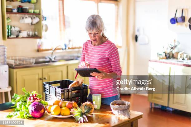 Senior woman checking her fresh vegetable delivery