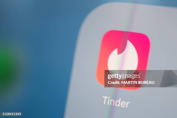 This illustration picture taken on July 24, 2019 in Paris shows the logo of the US social networking application Tinder on the screen of a tablet.