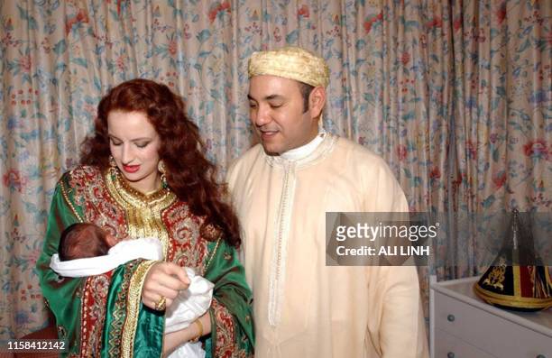Her Royal Higness Princess Lalla Salma holds the newborn Crown Prince Moulay Hassan as his father Moroccan King Mohammed VI looks on at the royal...