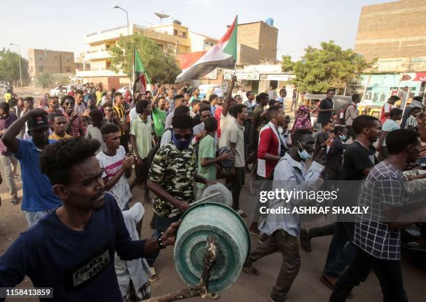 Sudanese protesters beat on makeshift drums and chant slogans during a rally in the capital Khartoum to condemn the "massacre" of five demonstrators...