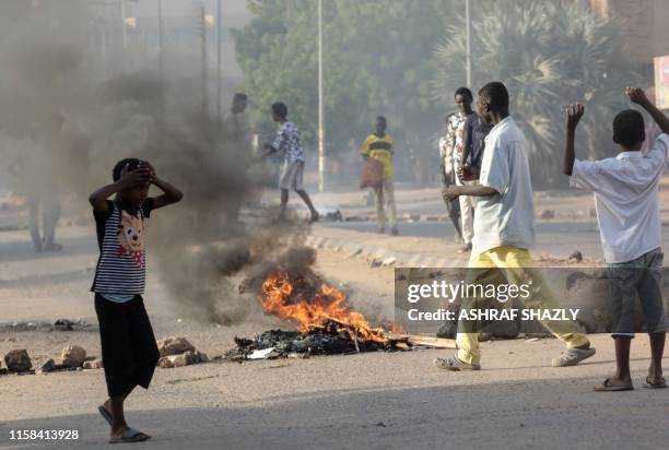 Sudanese protesters burn tires during a rally in the capital Khartoum to condemn the "massacre" of five demonstrators including four high school...