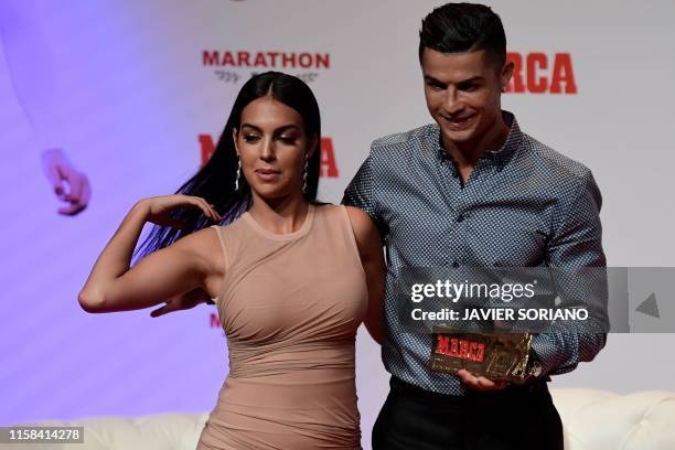 Portugal and Juventus forward Cristiano Ronaldo poses with his partner and Spanish model Georgina Rodriguez after receiving the MARCA Leyenda award...