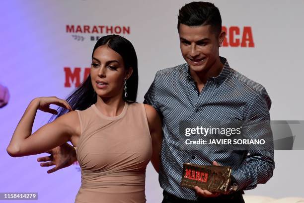 Portugal and Juventus forward Cristiano Ronaldo poses with his partner and Spanish model Georgina Rodriguez after receiving the MARCA Leyenda award...