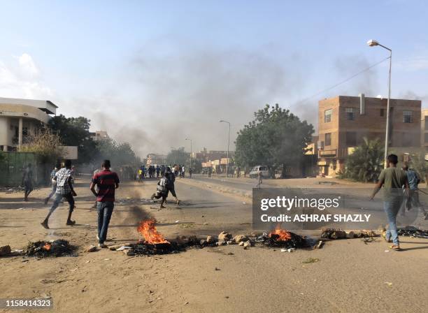 Tires are set ablaze by Sudanese protesters during a rally in the capital Khartoum to condemn the "massacre" of five demonstrators including four...