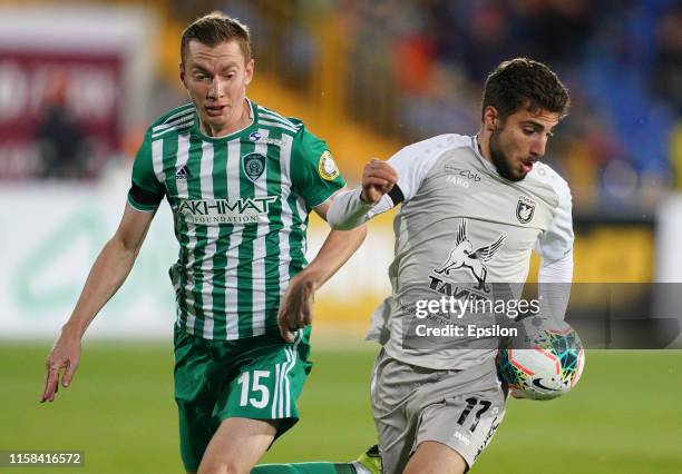 Zuriko Davitashvili of FC Rubin Kazan and Andrei Semyonov of FC Akhmat Grozny vie for the ball during the Russian Football League match between FC...