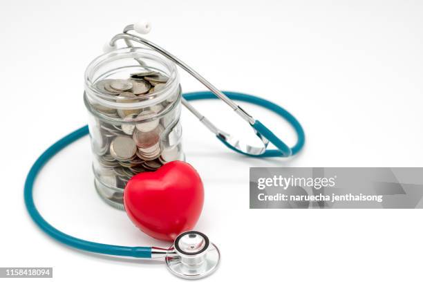 saving money for medical concept - piggy bank doctor fotografías e imágenes de stock